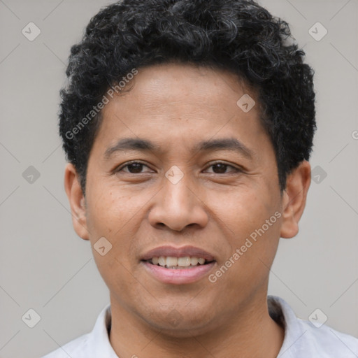 Joyful latino young-adult male with short  brown hair and brown eyes