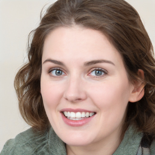 Joyful white young-adult female with medium  brown hair and blue eyes