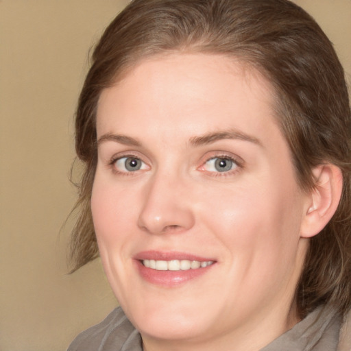 Joyful white young-adult female with medium  brown hair and blue eyes