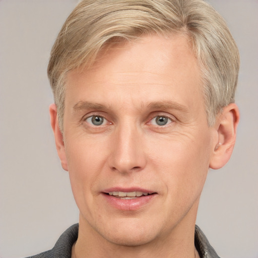 Joyful white adult male with short  brown hair and grey eyes