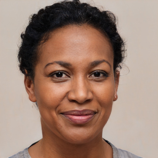 Joyful black adult female with short  brown hair and brown eyes