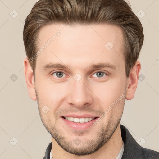 Joyful white young-adult male with short  brown hair and grey eyes