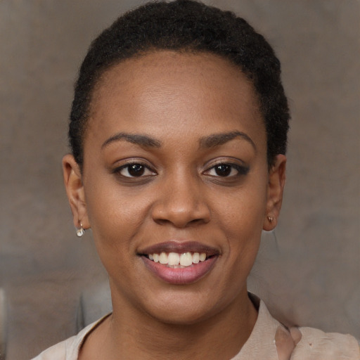 Joyful black young-adult female with short  brown hair and brown eyes