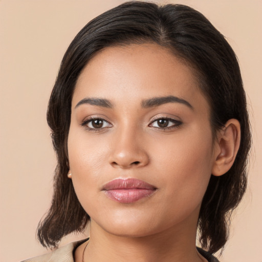 Joyful latino young-adult female with long  brown hair and brown eyes