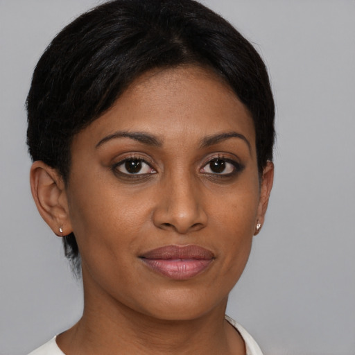 Joyful black young-adult female with short  brown hair and brown eyes