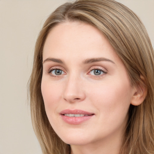 Joyful white young-adult female with long  brown hair and blue eyes