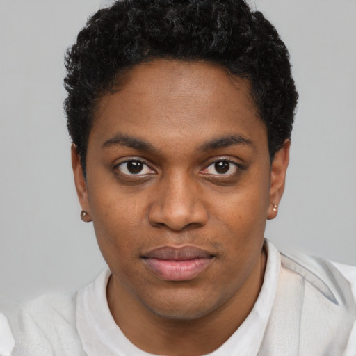 Joyful black young-adult male with short  brown hair and brown eyes
