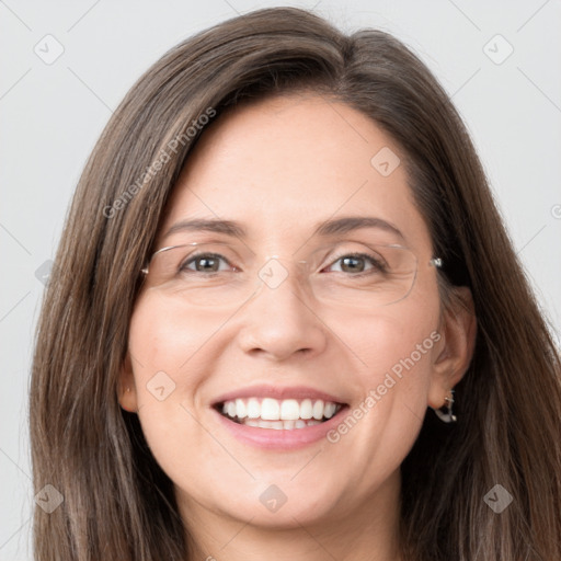 Joyful white young-adult female with long  brown hair and grey eyes