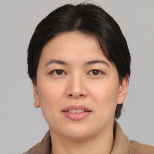 Joyful asian adult female with short  brown hair and brown eyes