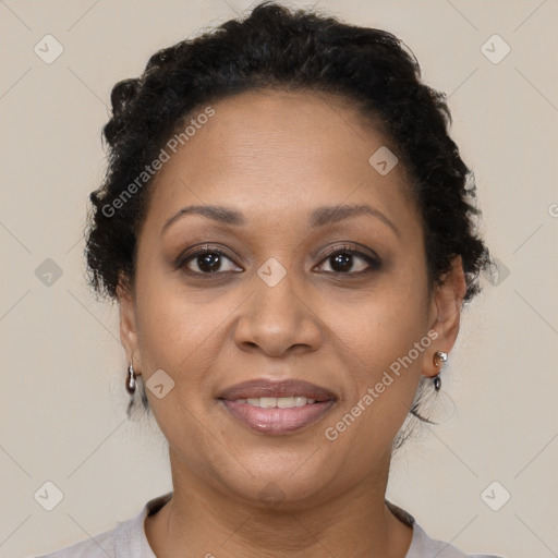 Joyful black adult female with short  brown hair and brown eyes