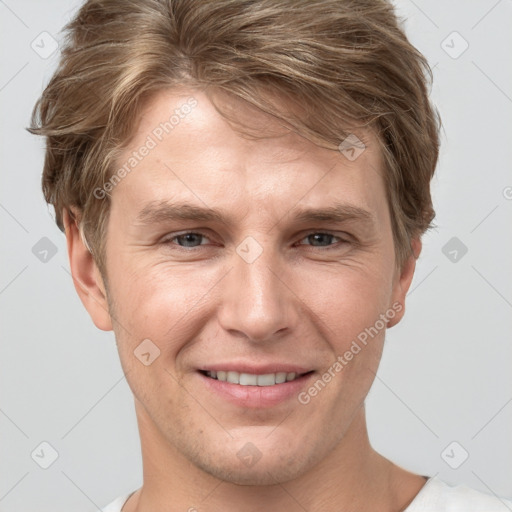 Joyful white adult male with short  brown hair and grey eyes