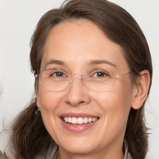 Joyful white adult female with medium  brown hair and brown eyes