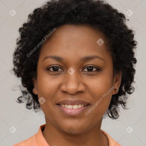 Joyful black young-adult female with long  brown hair and brown eyes