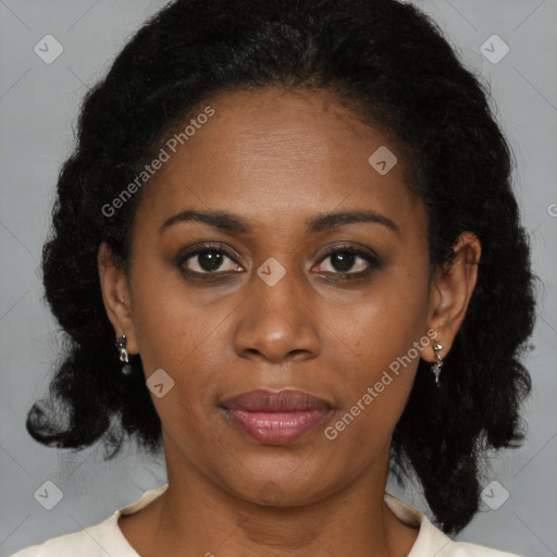 Joyful black adult female with medium  brown hair and brown eyes