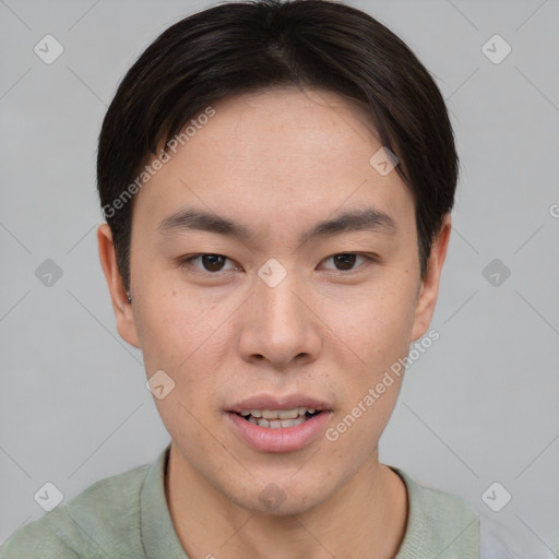 Joyful asian young-adult male with short  brown hair and brown eyes