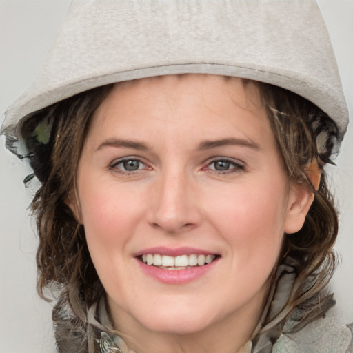 Joyful white young-adult female with medium  brown hair and blue eyes