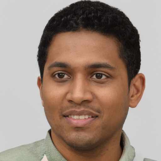 Joyful black young-adult male with short  black hair and brown eyes