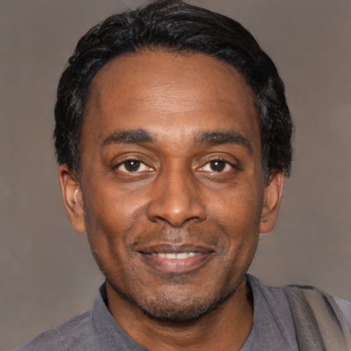 Joyful asian adult male with short  black hair and brown eyes