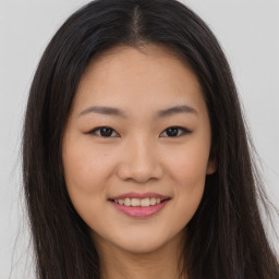 Joyful asian young-adult female with long  brown hair and brown eyes