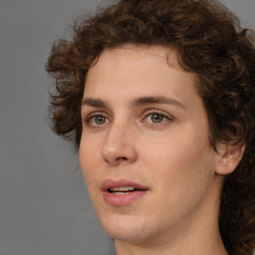 Joyful white young-adult male with medium  brown hair and brown eyes