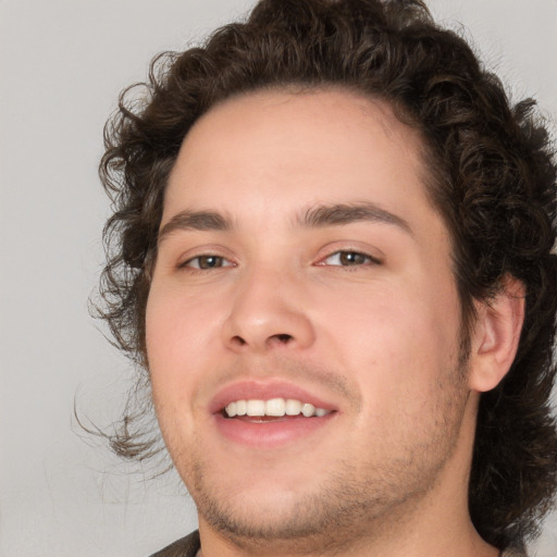 Joyful white young-adult male with medium  brown hair and brown eyes