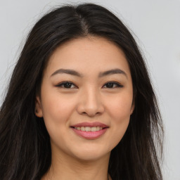 Joyful asian young-adult female with long  brown hair and brown eyes