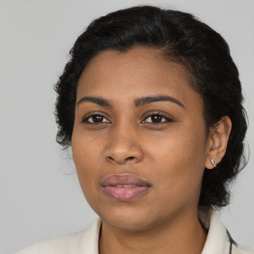 Joyful black young-adult female with medium  black hair and brown eyes
