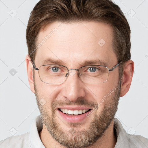 Joyful white adult male with short  brown hair and grey eyes