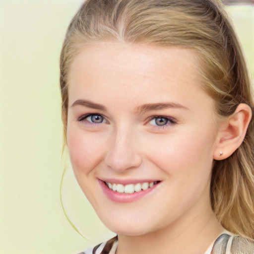 Joyful white young-adult female with long  brown hair and blue eyes