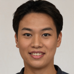 Joyful asian young-adult male with short  black hair and brown eyes