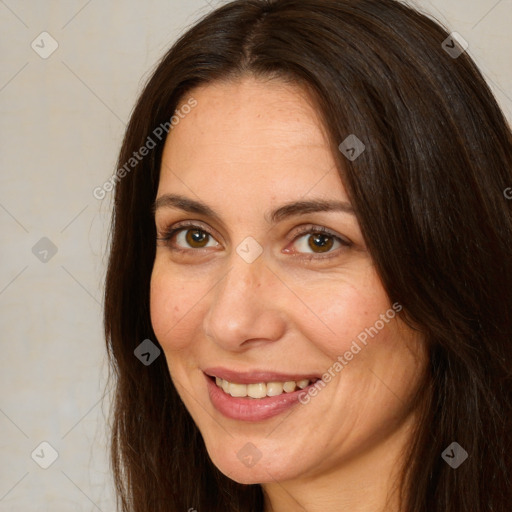 Joyful white adult female with long  brown hair and brown eyes