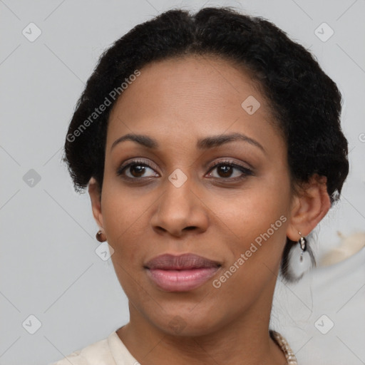 Joyful black young-adult female with short  black hair and brown eyes