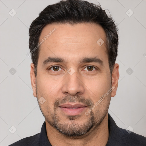 Joyful white adult male with short  black hair and brown eyes