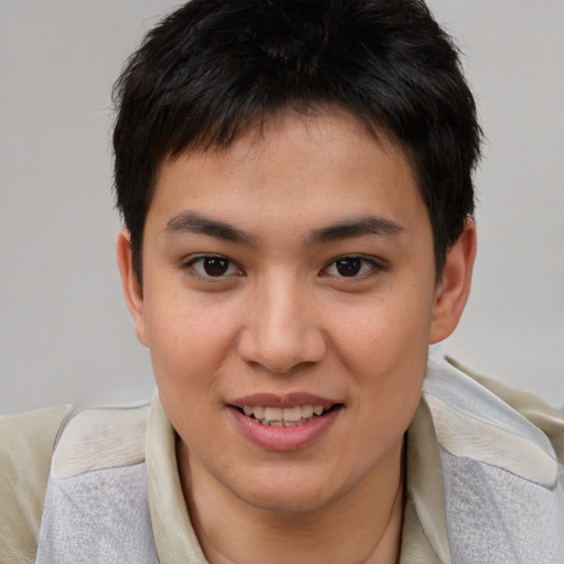 Joyful asian young-adult male with short  brown hair and brown eyes