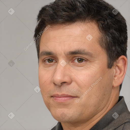 Joyful white adult male with short  brown hair and brown eyes