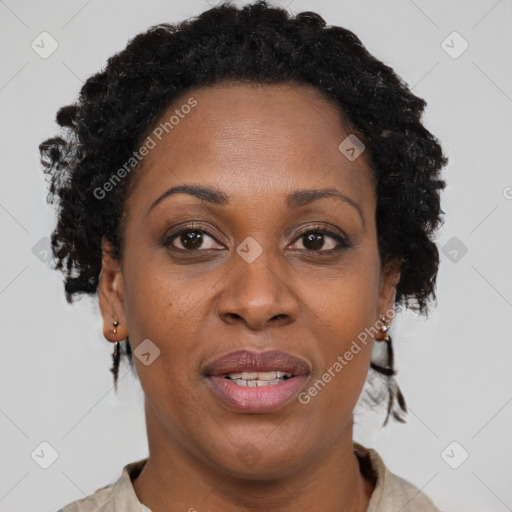 Joyful black adult female with short  brown hair and brown eyes