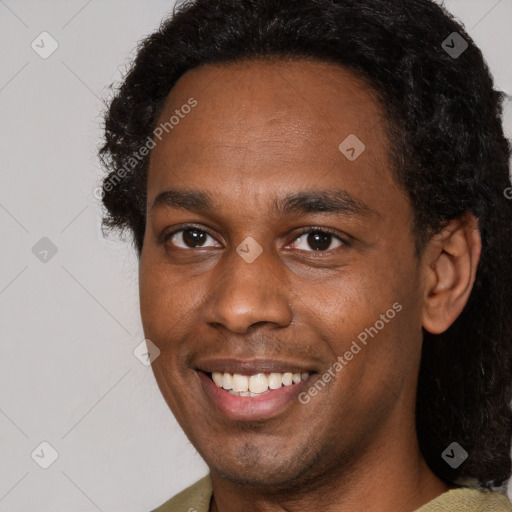 Joyful black young-adult male with short  brown hair and brown eyes