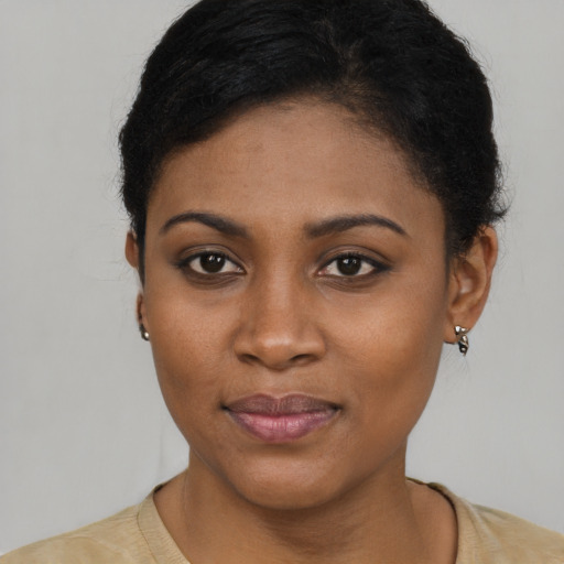Joyful black young-adult female with short  brown hair and brown eyes