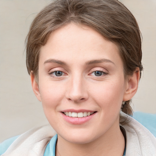 Joyful white young-adult female with medium  brown hair and blue eyes