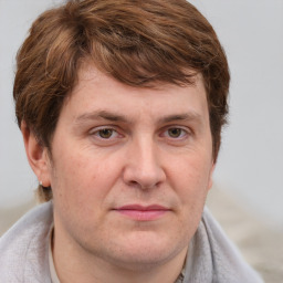 Joyful white adult male with short  brown hair and grey eyes