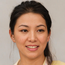 Joyful asian young-adult female with medium  brown hair and brown eyes