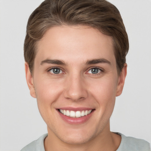 Joyful white young-adult female with short  brown hair and grey eyes