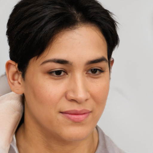 Joyful latino young-adult female with medium  brown hair and brown eyes