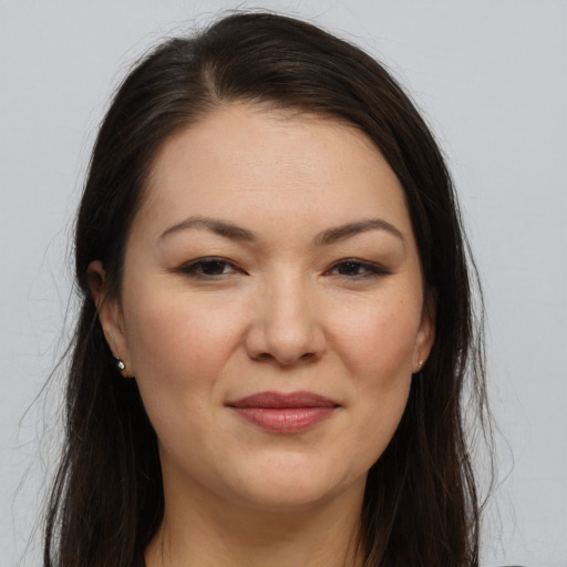 Joyful white young-adult female with long  brown hair and brown eyes