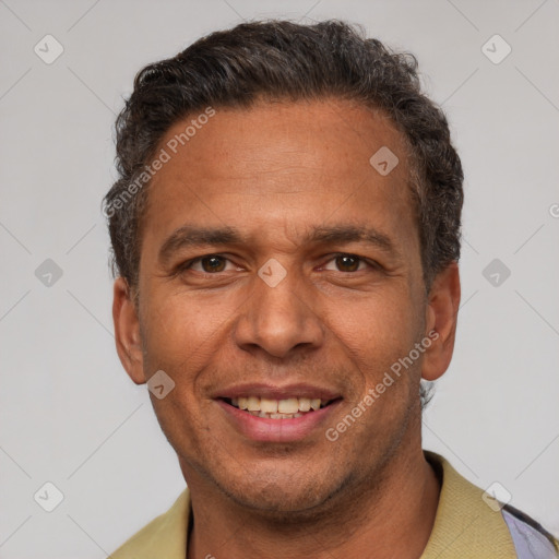 Joyful latino adult male with short  brown hair and brown eyes