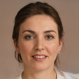 Joyful white adult female with medium  brown hair and grey eyes