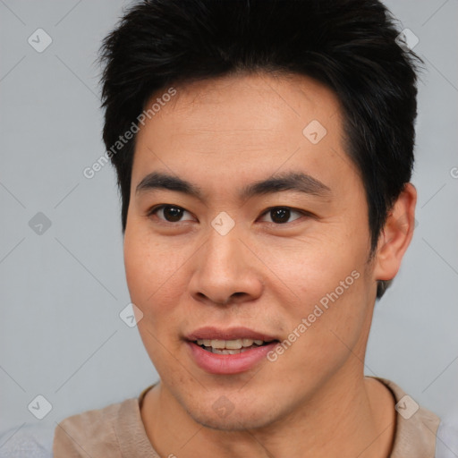 Joyful asian young-adult male with short  brown hair and brown eyes