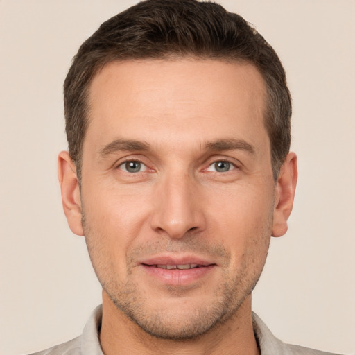 Joyful white adult male with short  brown hair and brown eyes