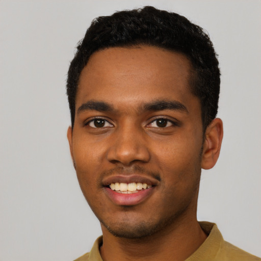 Joyful black young-adult male with short  black hair and brown eyes