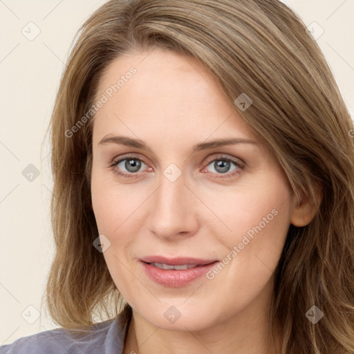 Joyful white young-adult female with long  brown hair and blue eyes